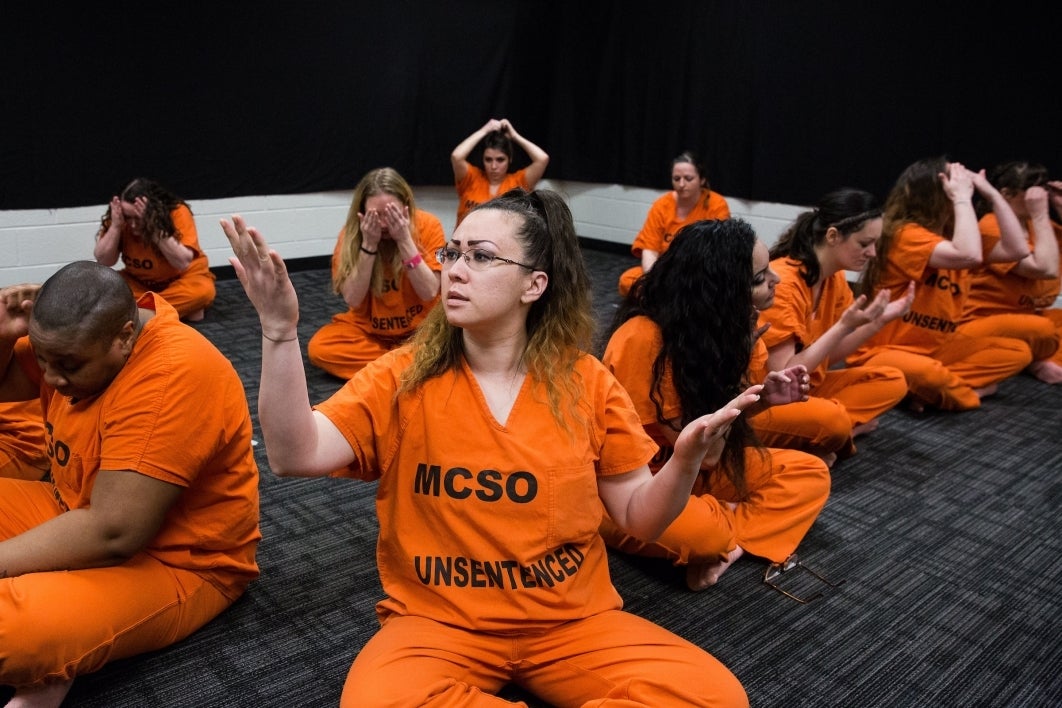 Women perform a seated dance