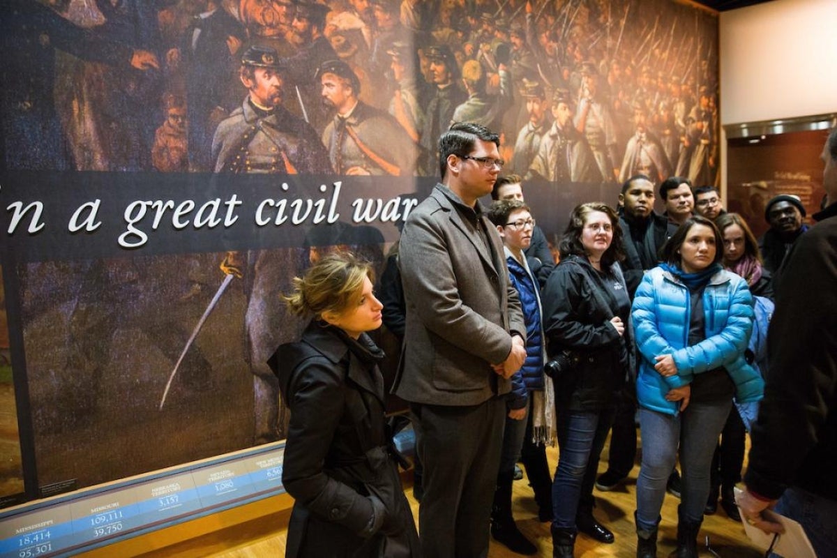 Students standing against a wall