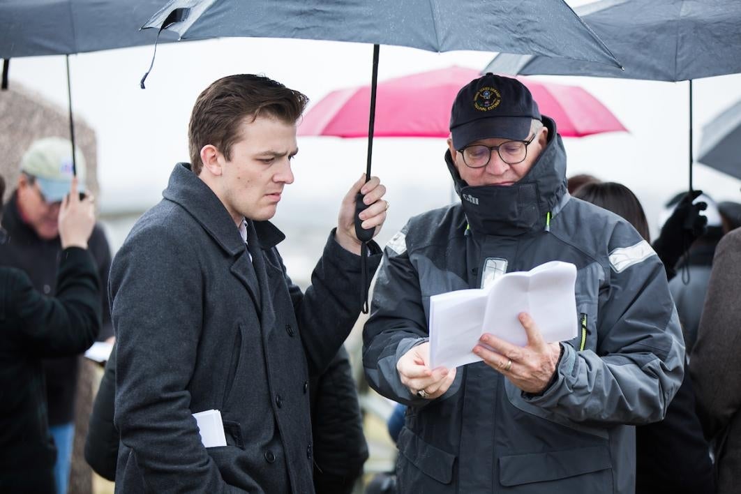 Two men under an umbrella