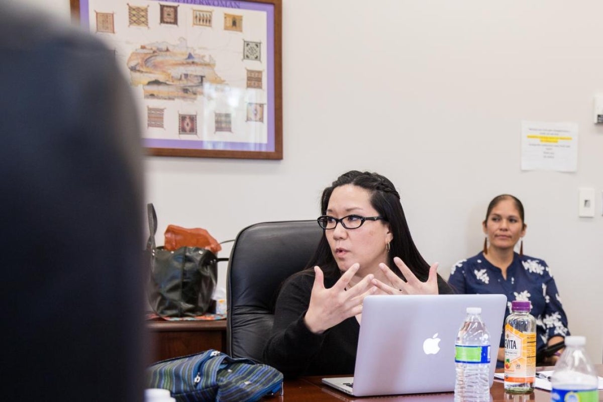 Women behind laptop