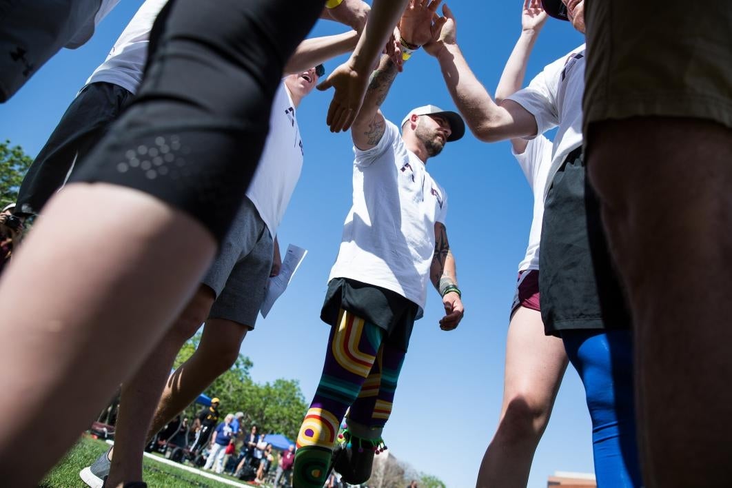 A team huddles before an obstacle course race