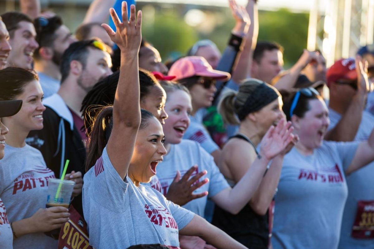 group of people cheering at a race