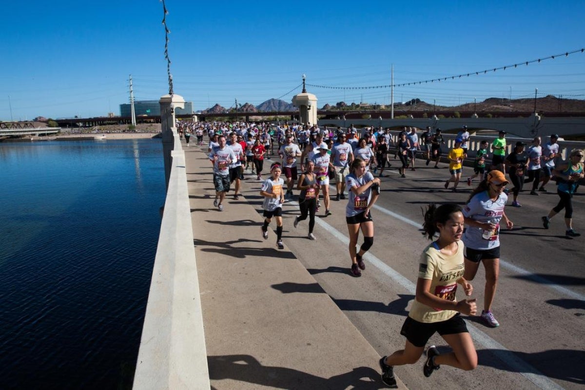 people running across bridge