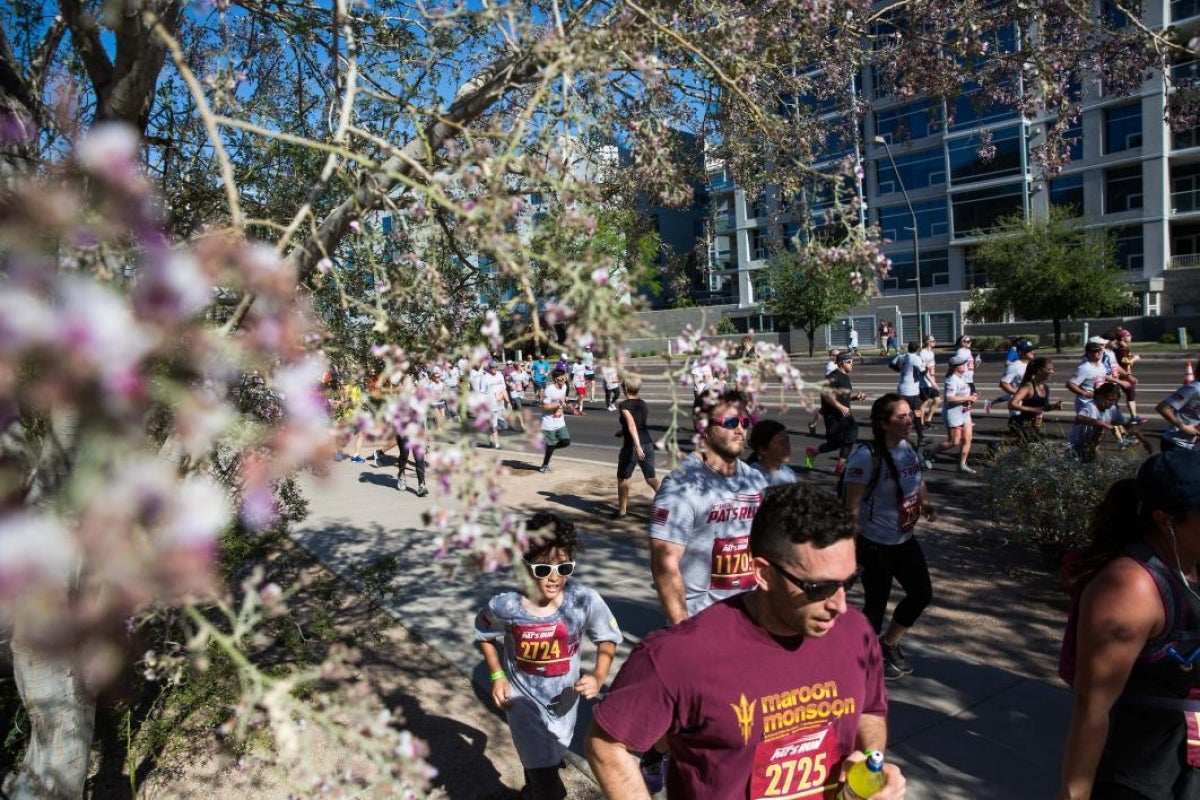 people running past flowers