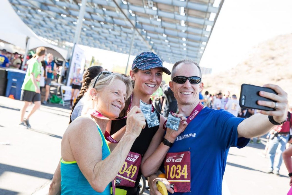 three people taking a group selfie