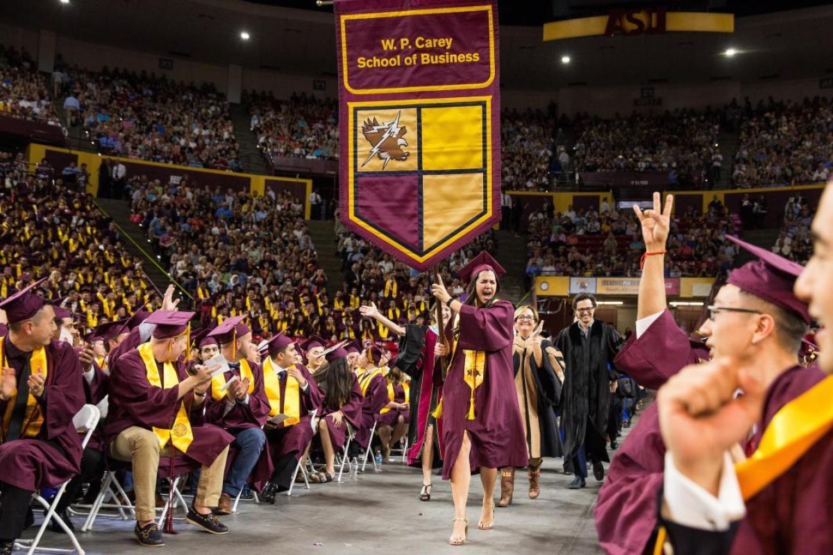 graduate carrying banner