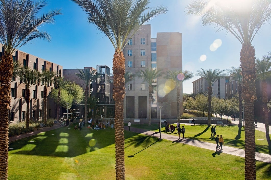 A complex of Barrett honors college buildings shown with green lawns and students walking