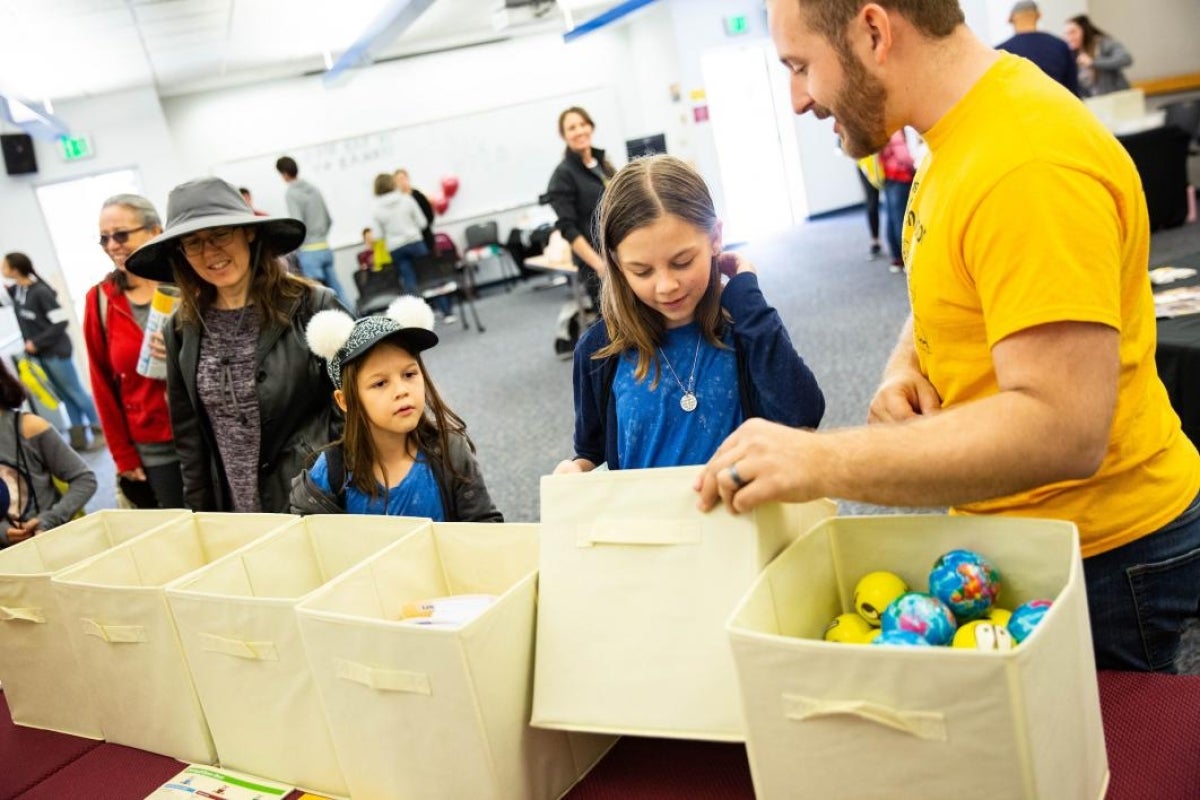 girls choosing prizes from a bin