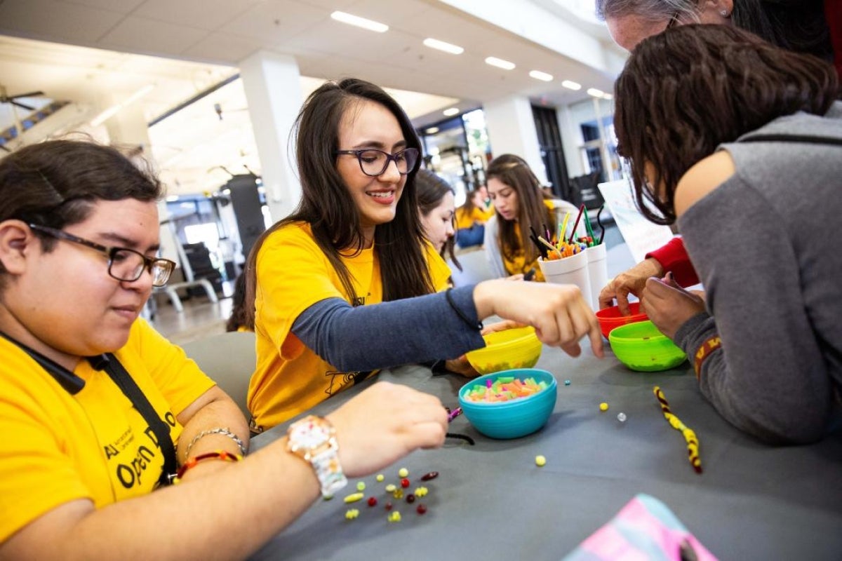 girls make beaded bracelets