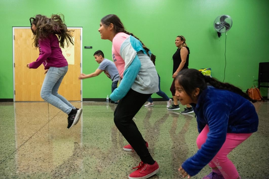 kids hopping across a floor