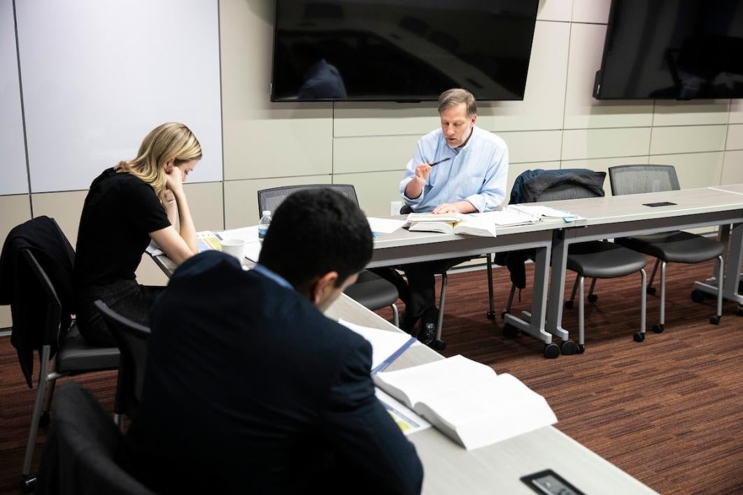 Three people in a classroom