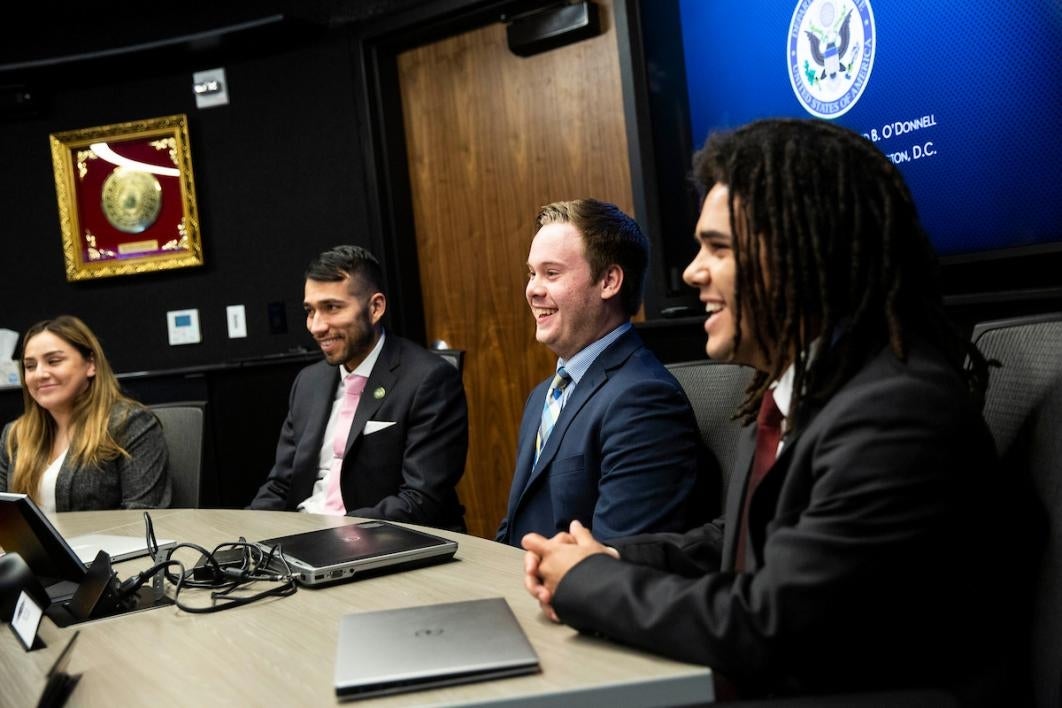 Four students in a conference room