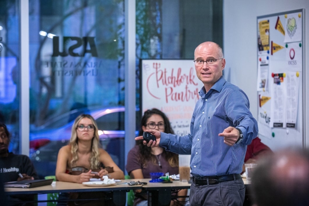 man lecturing to a classroom