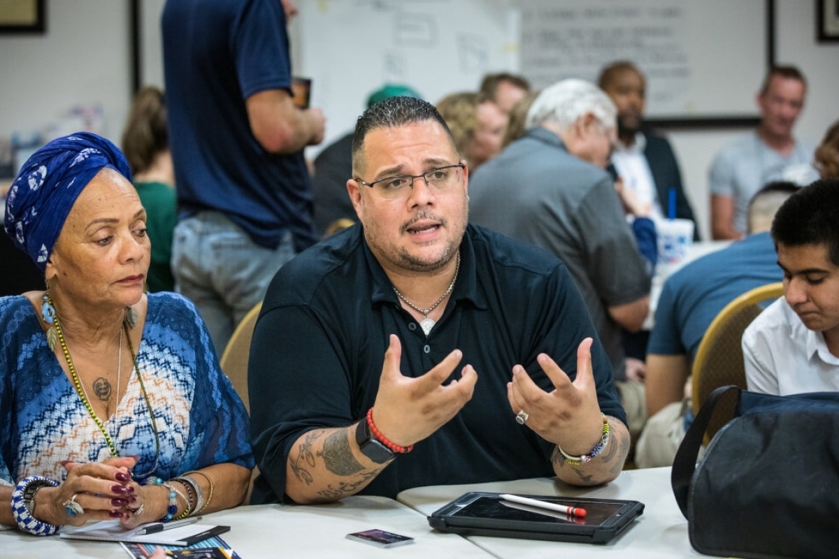 Man with tattoos in discussion