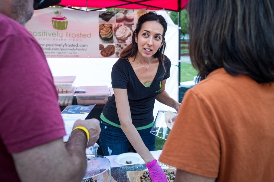 andi Barstow offers Positively Frosted samples to visitors