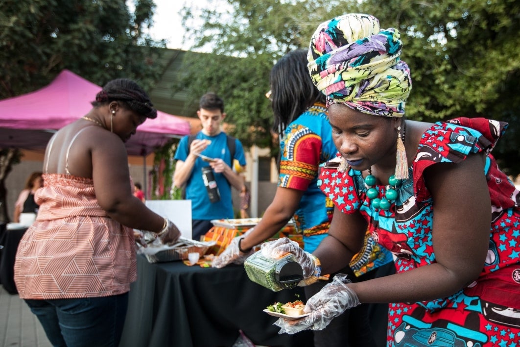 Ohemaa Afro Fusion Cuisine server Lovelyn Omari prepares a dish