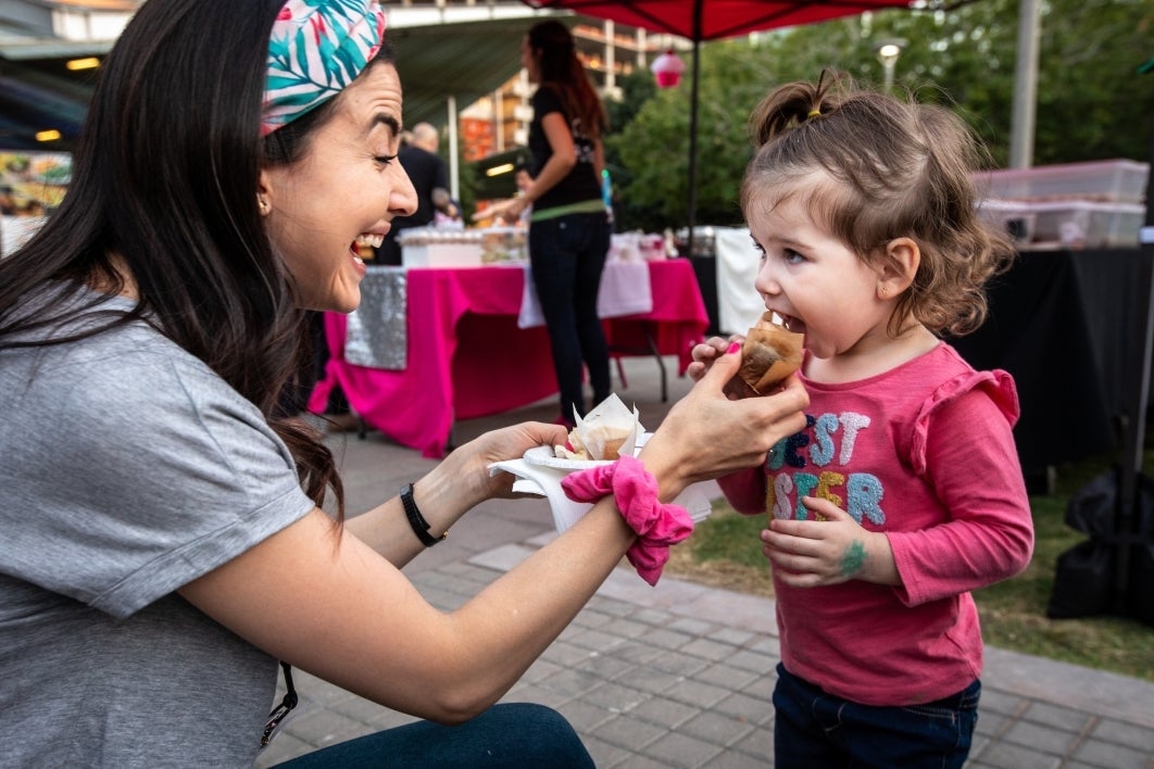 Maria Hernandez offers her two-year-old daughter Almudena Cerecedo a small cupcake