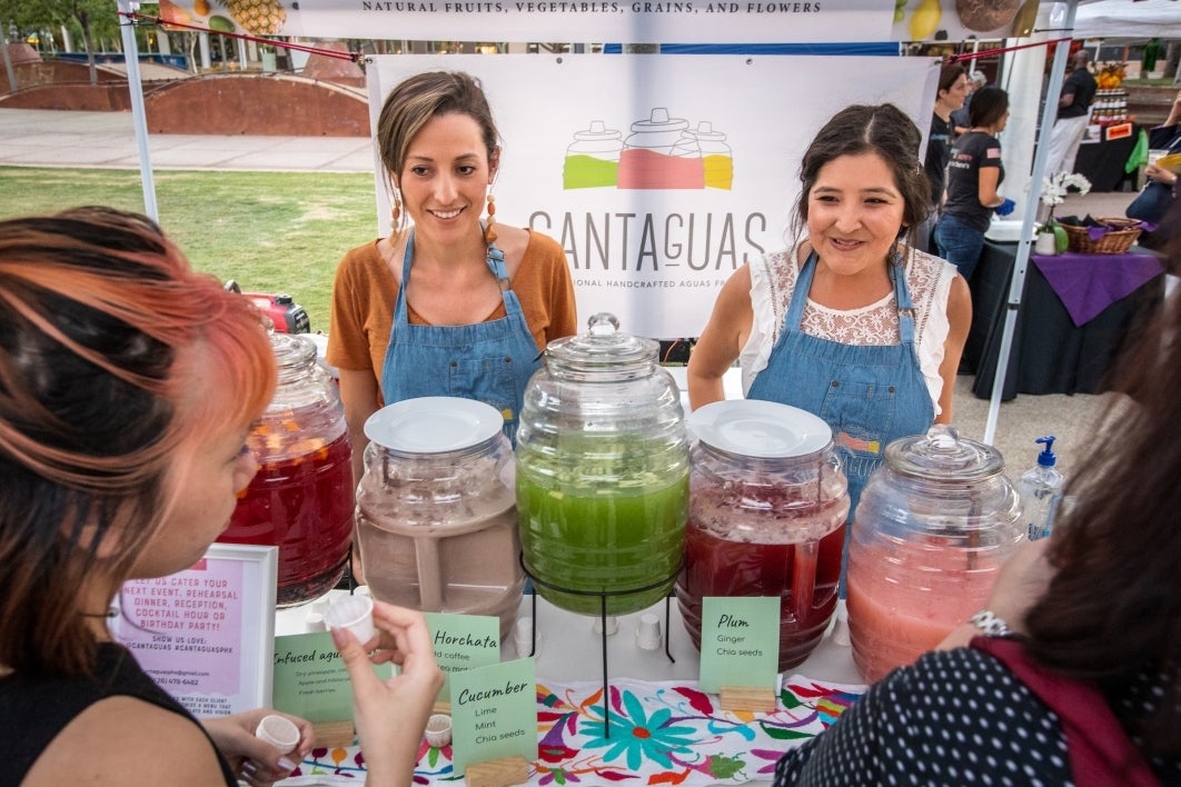 Cantaguas owners Elva Covarrubias, left, and Irene Gonzalez speak with visitors