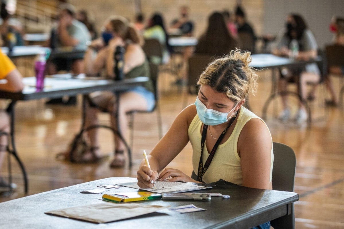 student sitting at table taking notes