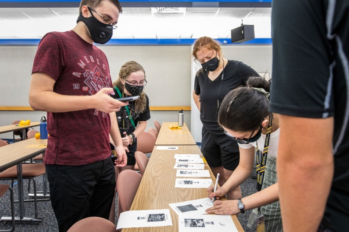 people writing something down on a piece of paper