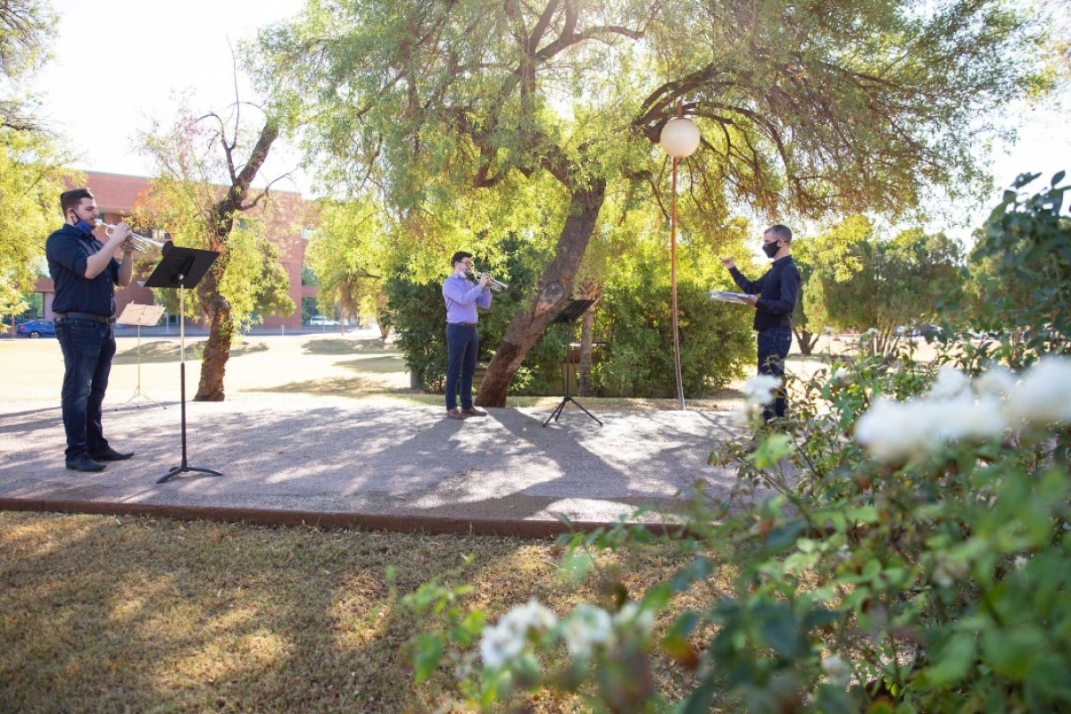 A trumpet class practices outside ASU Gammage