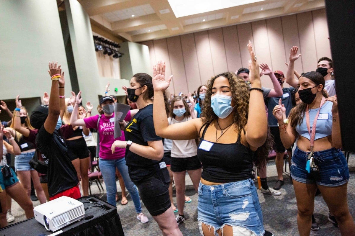 Students cheering in a ballroom