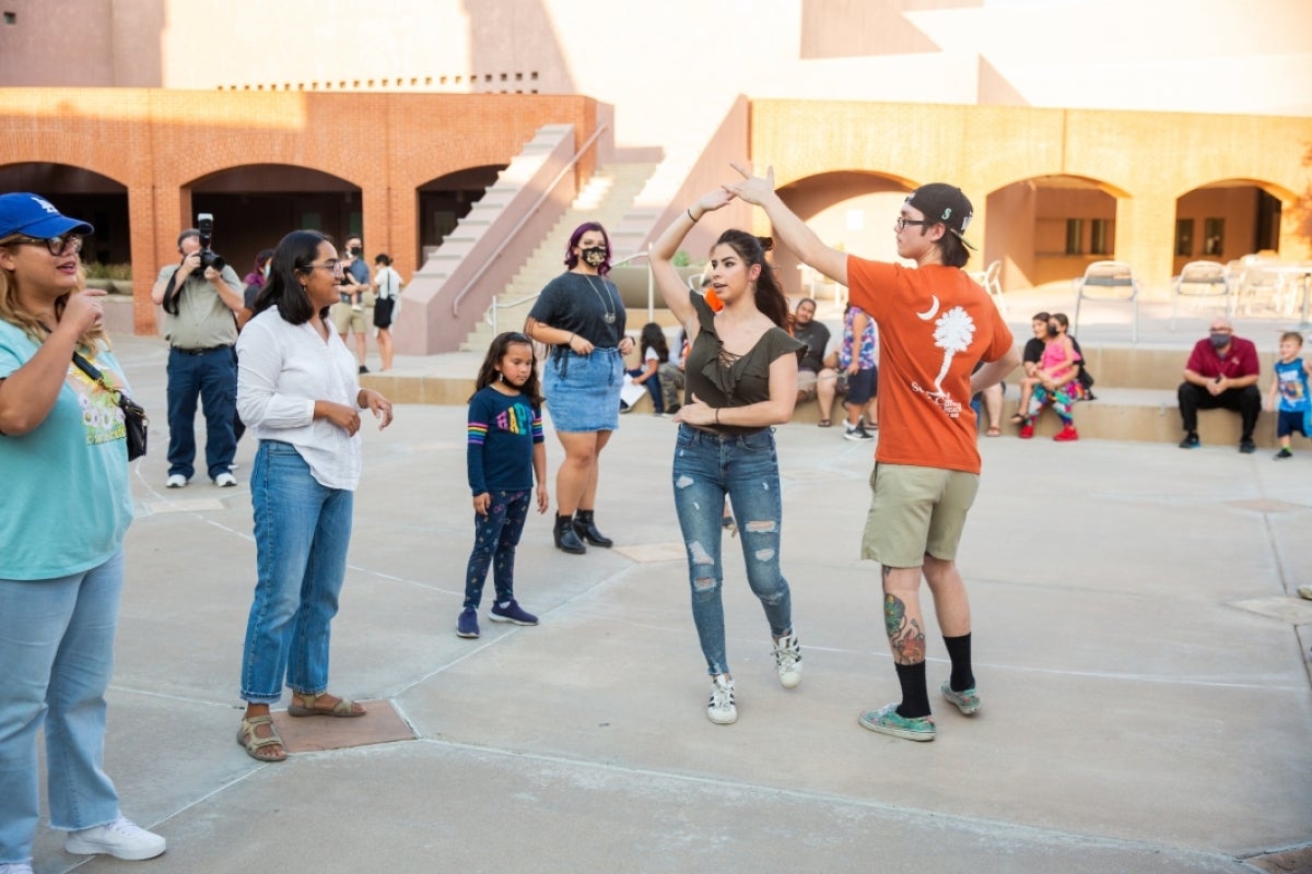 People dance in a courtyard