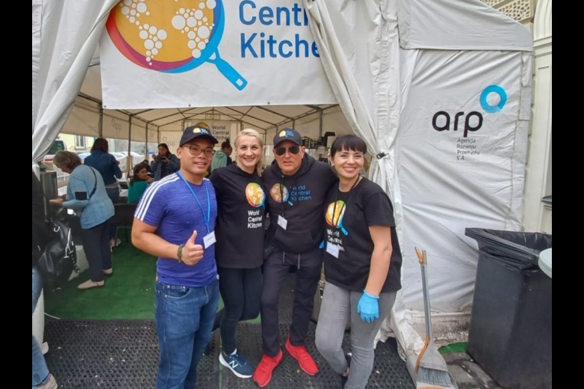 Jarrod standing with coworkers at World Central Kitchen in Poland