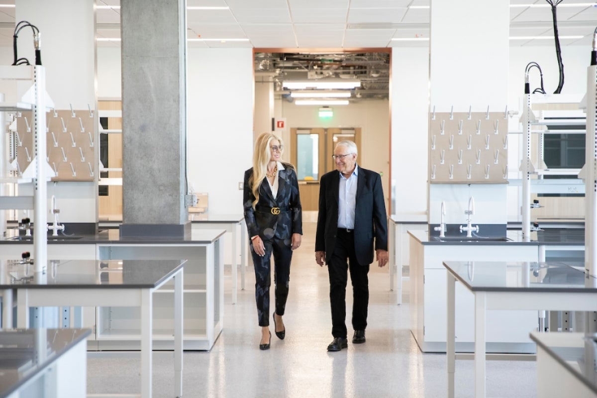 Rob and Melani Waltoo walk through a wet lab in ISTB7