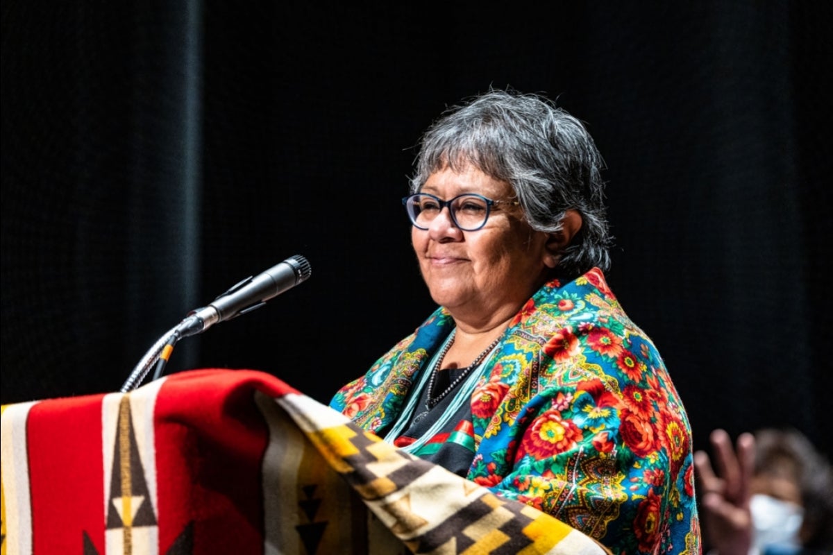 A woman speaks at a lectern