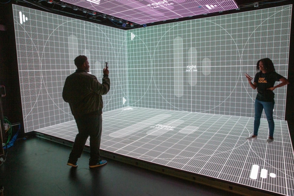 Students taking photo of a Planar screen with grid marks