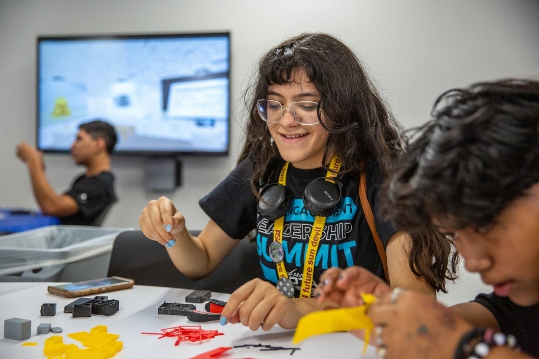 high schoolers work on building 3-D printed models