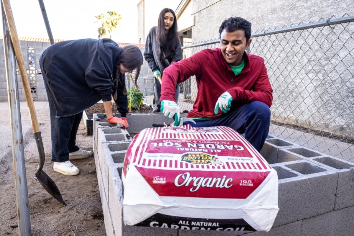 Student opens bag of soil