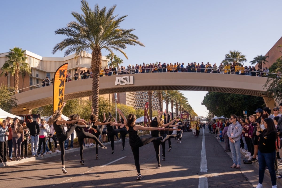 People watching dancers in a homecoming parade