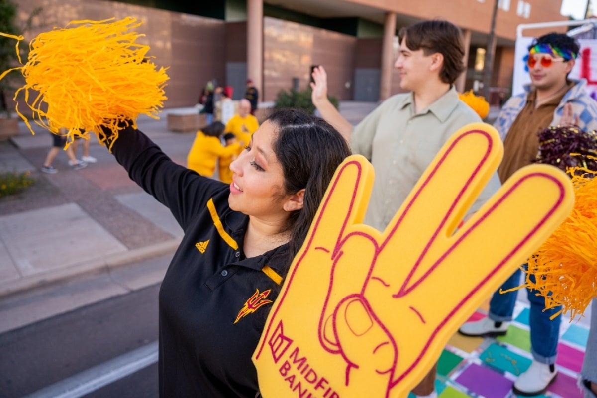 Woman waving pompom during parade