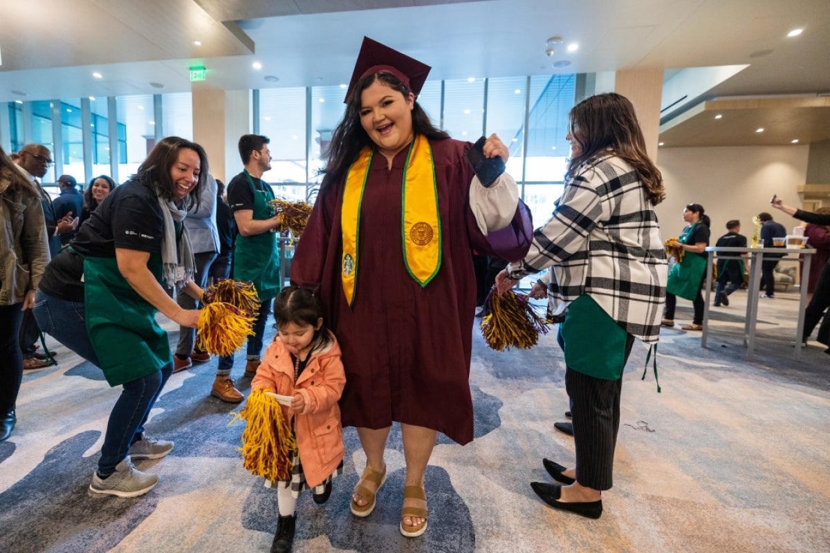 Grad and daughter pose for photo at Starbucks event