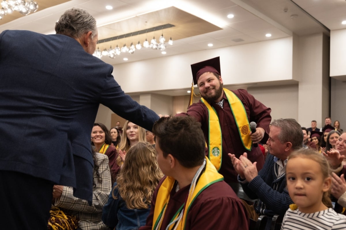 Two men shaking hands at event