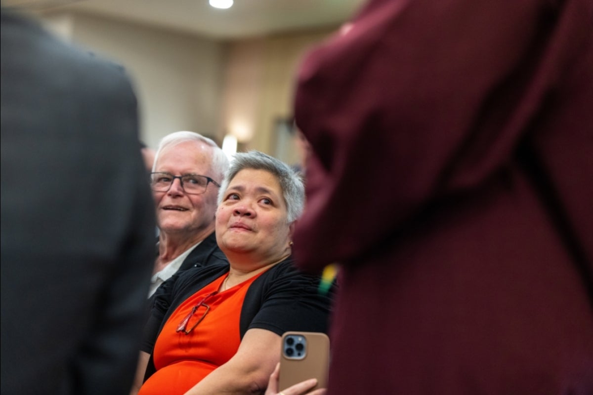 Man and woman listening in audience