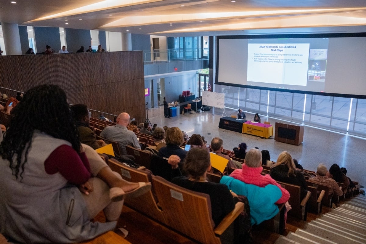 People seated in a lecture hall.