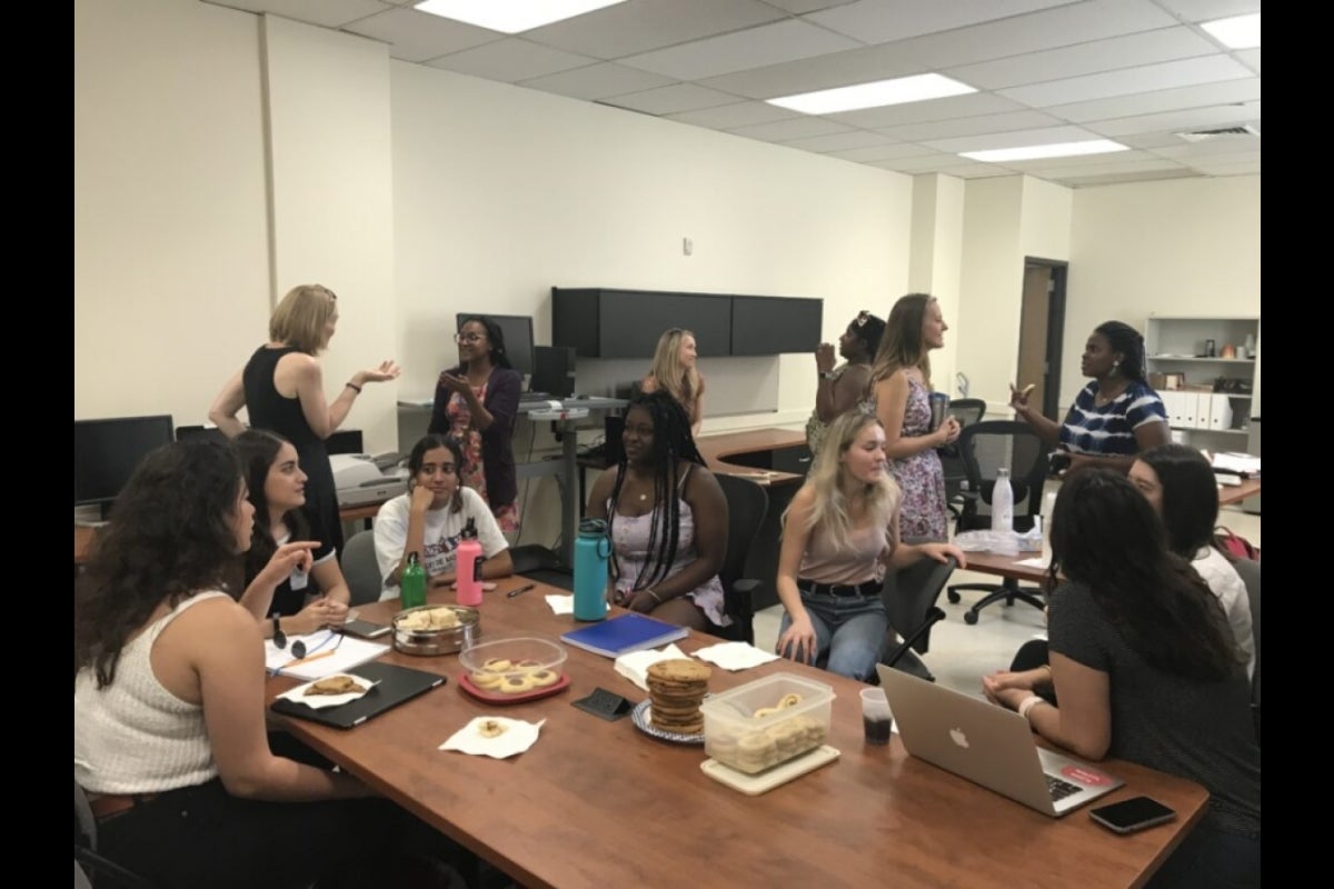 Students socializing in a classroom.