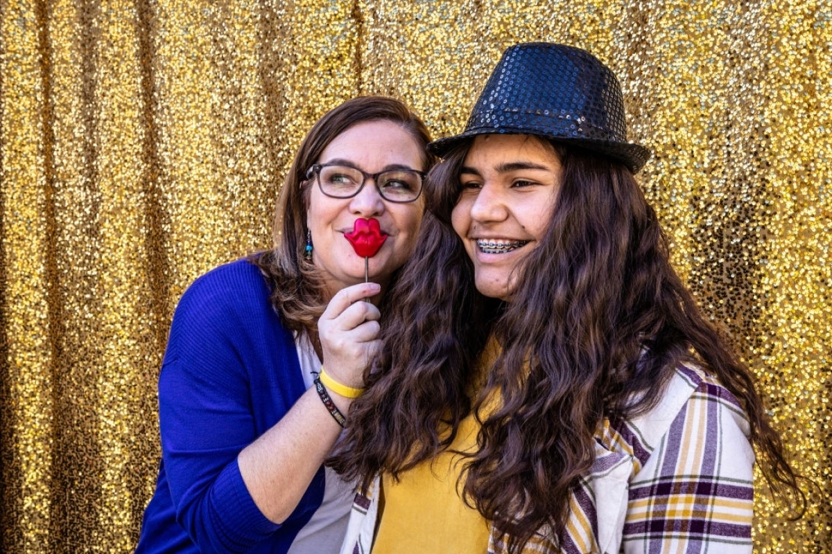 Mother and daughter take a picture at photo booth