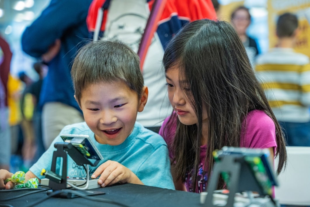 Young children playing with an Arduino device