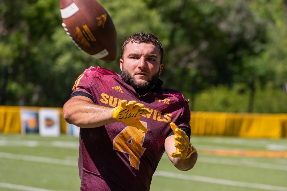 A football player catches a ball