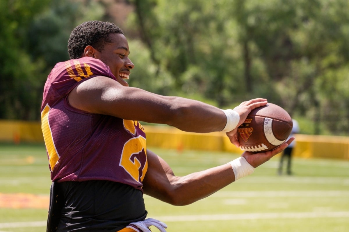 A football player catches a ball