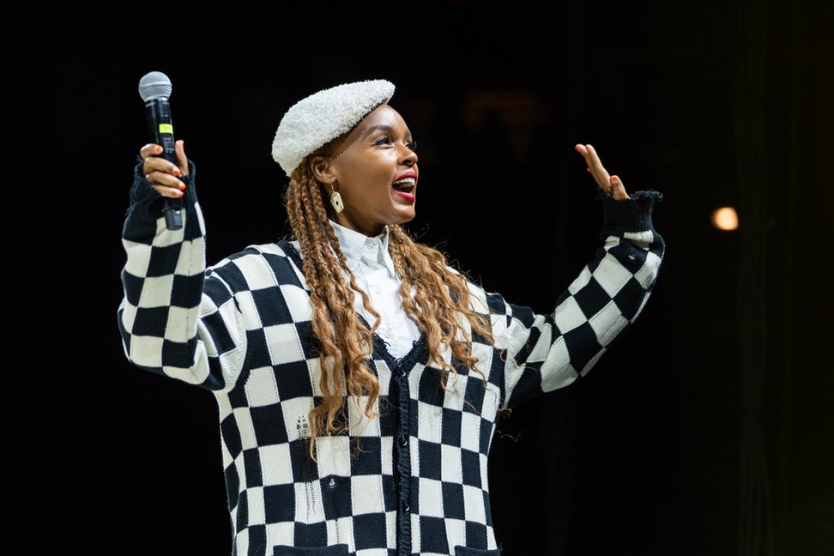 Janelle Monae smiles and waves as she walks on stage