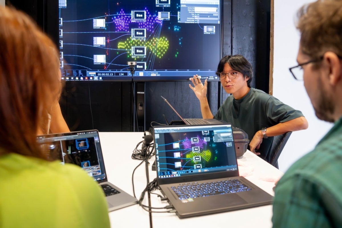 Professor and students look at drone renderings