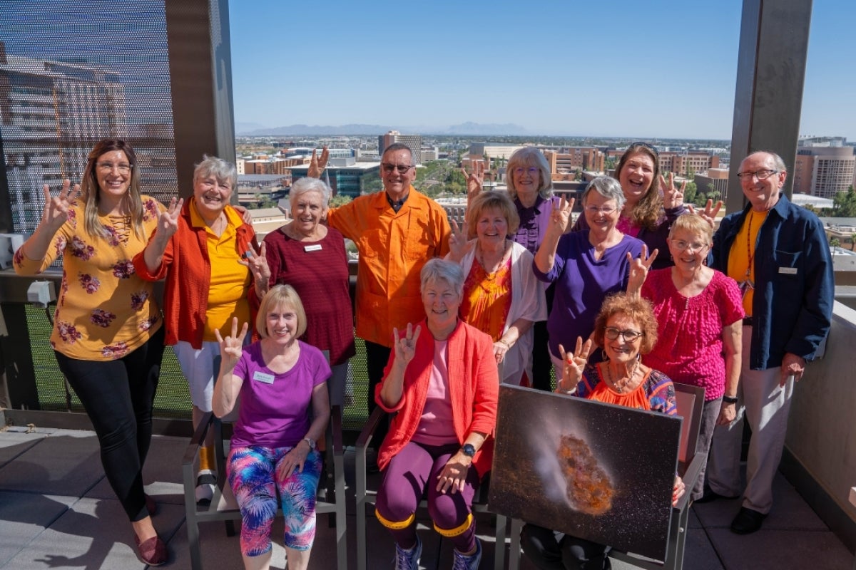 A group of people pose for a photo on a rooftop