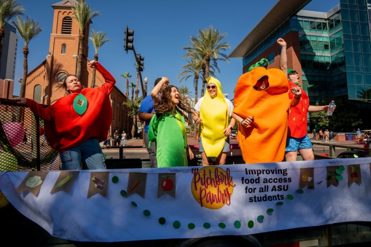 People dressed up as fruit on food pantry float