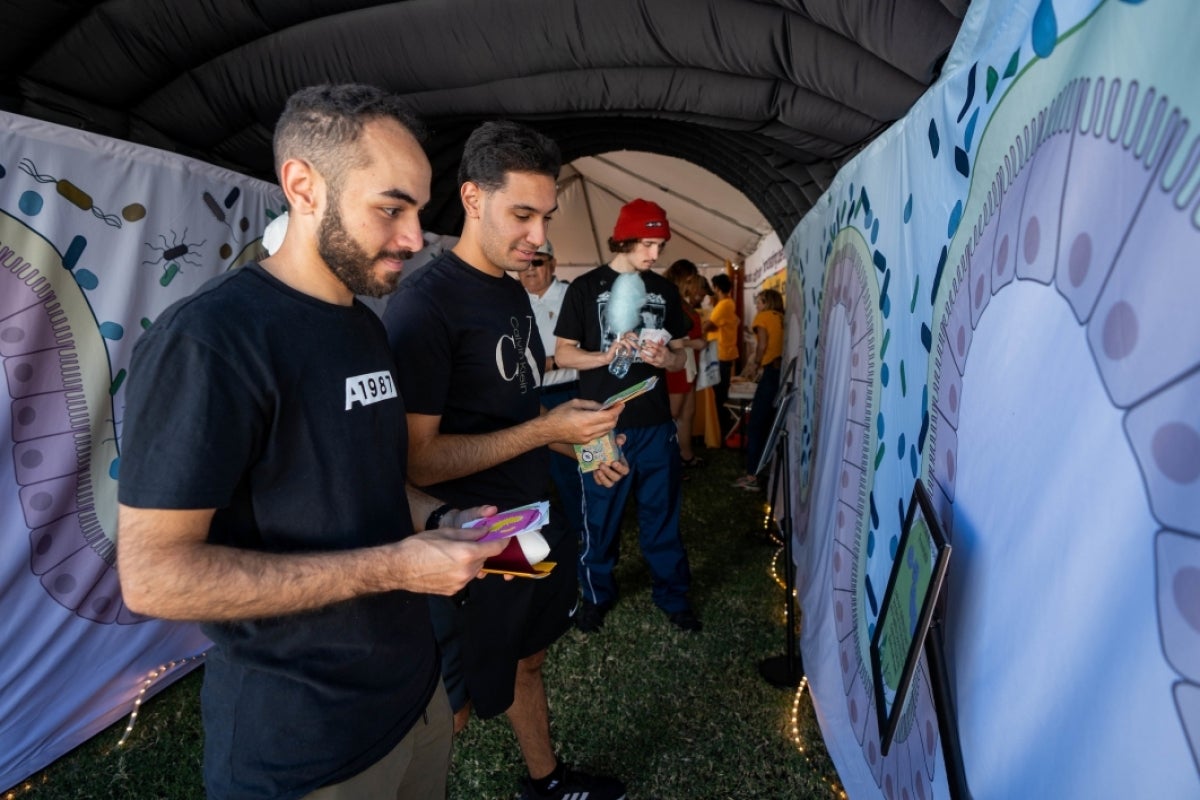 People interacting with science exhibit