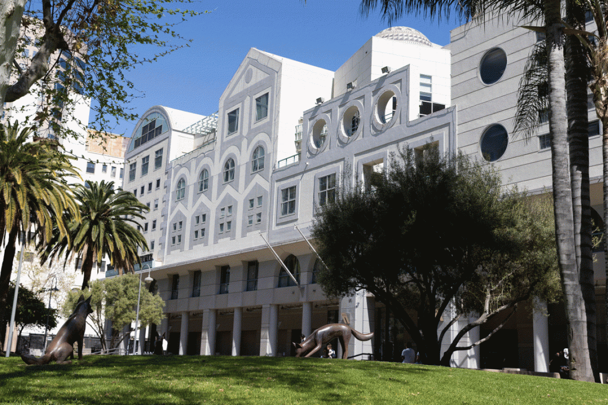 Exterior photo of a white building featuring many shapes of windows and trompe l'oeil architectural details